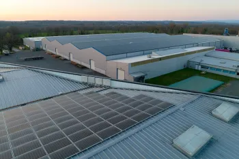 aerial-view-blue-photovoltaic-solar-panels-mounted-industrial-building-roof-producing-green-ecological-electricity-production-sustainable-energy-concept-copy